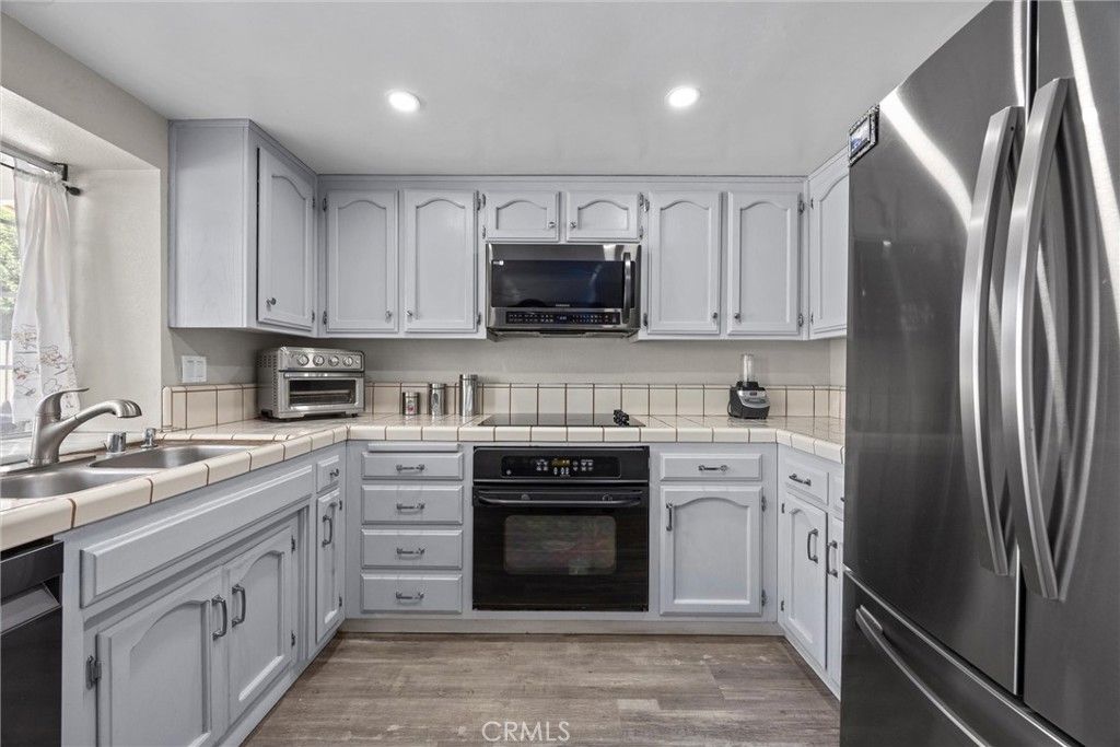 Interior, Kitchen, Recessed Lighting, Stainless Steel Appliances, Tile Countertops, Wood Texture Flooring