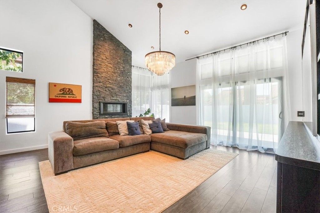 Chandelier, Fireplace, Interior, Living room, Recessed Lighting, Stone Walls, Wood Texture Flooring