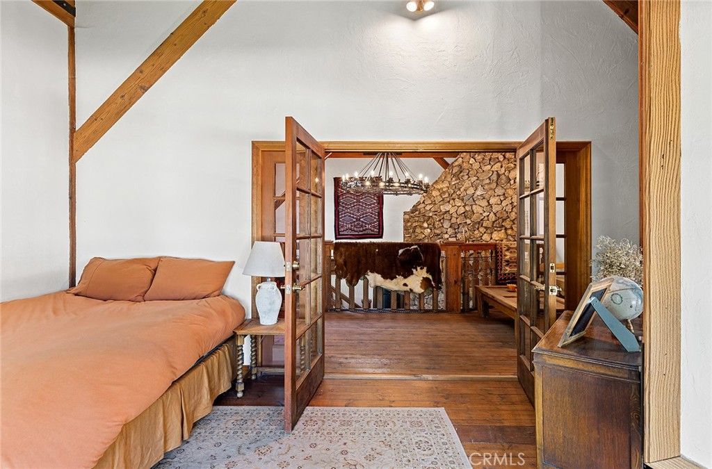 Bedroom, Chandelier, Fireplace, Interior, Stone Walls, Wood Texture Flooring