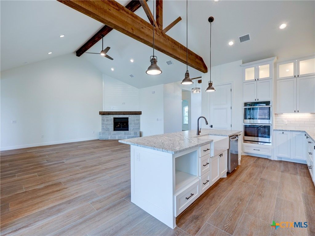 Empty room, Fireplace, Interior, Kitchen, Pendant Lights, Recessed Lighting, Wooden Beams, Wood Texture Flooring