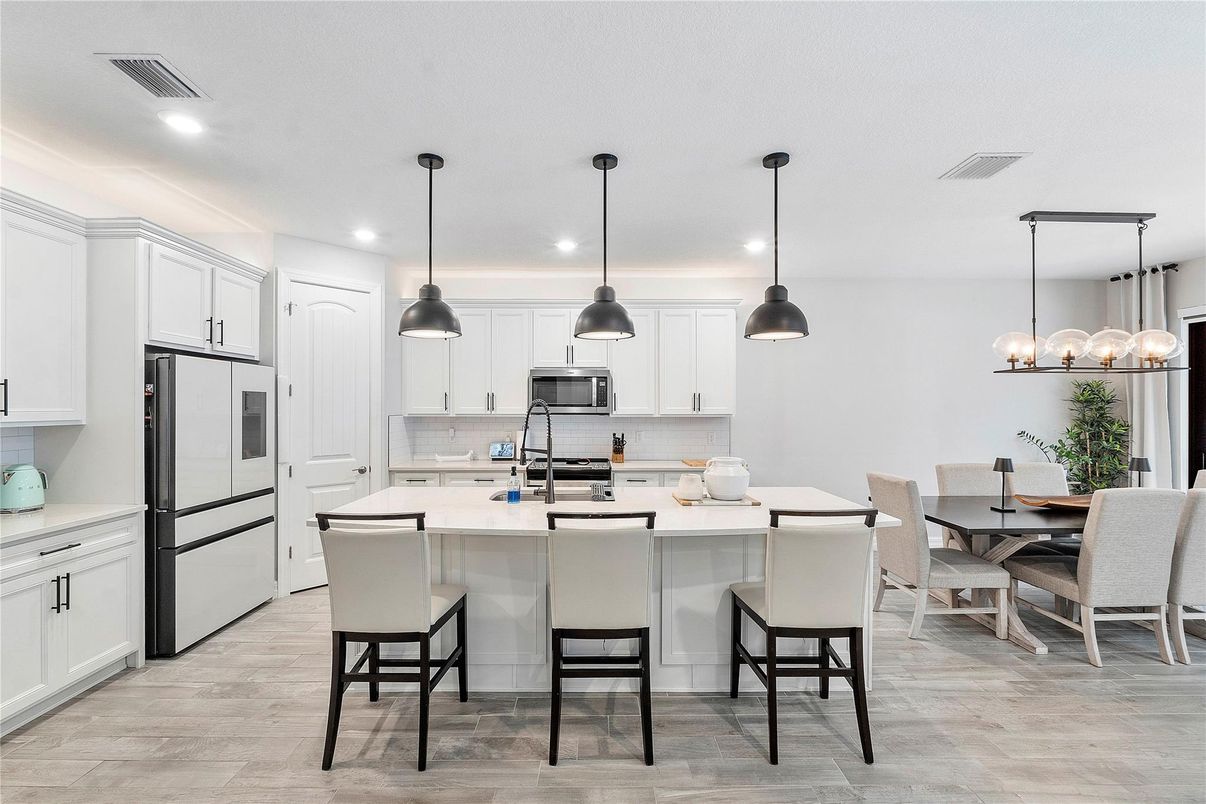 Dining room, Interior, Kitchen, Pendant Lights, Recessed Lighting, Stainless Steel Appliances, Wood Texture Flooring