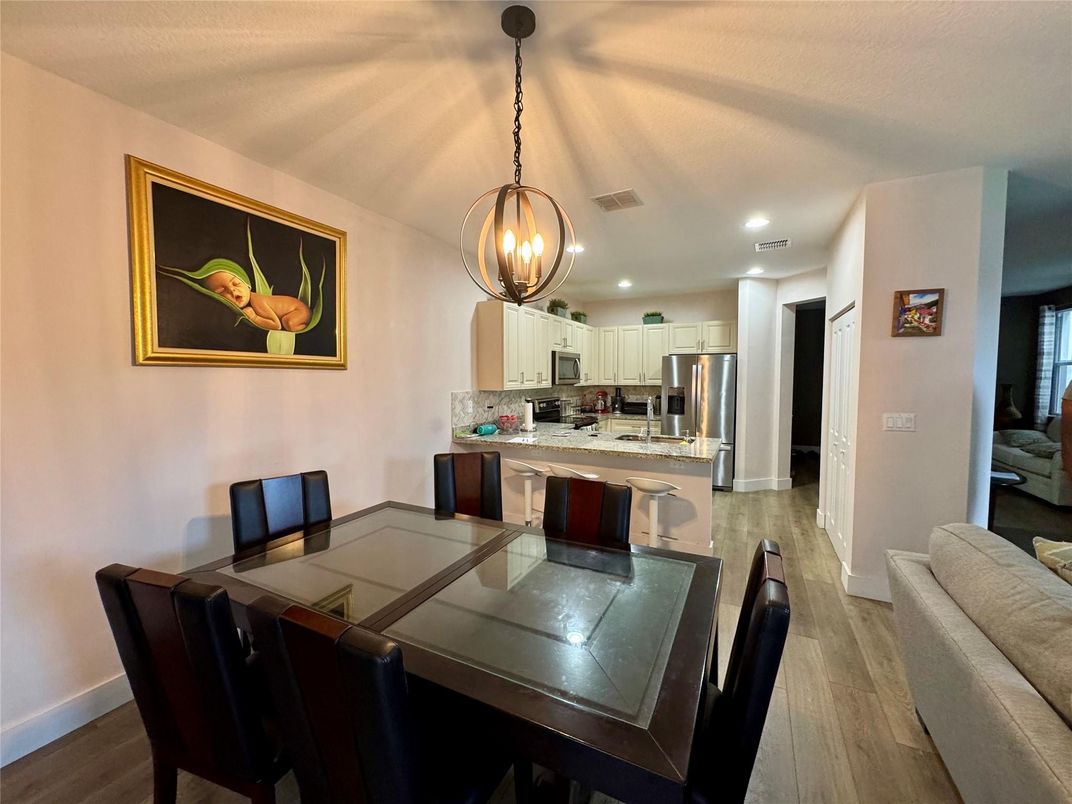 Dining room, Interior, Kitchen, Pendant Lights, Recessed Lighting, Stainless Steel Appliances, Wood Texture Flooring