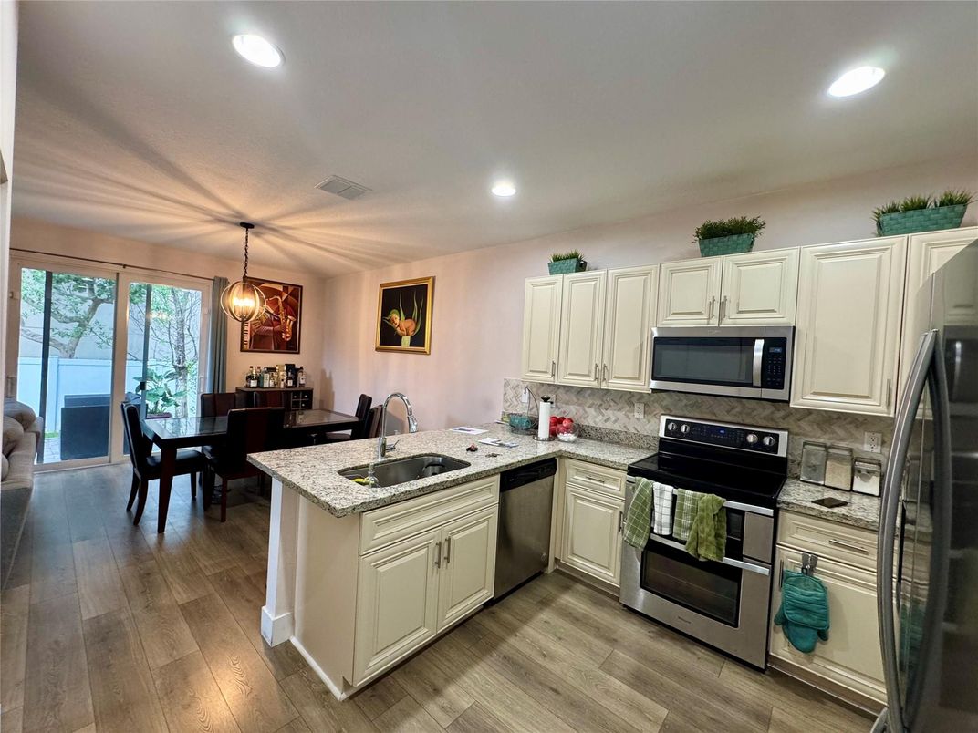 Dining room, Interior, Kitchen, Pendant Lights, Recessed Lighting, Stainless Steel Appliances, Wood Texture Flooring