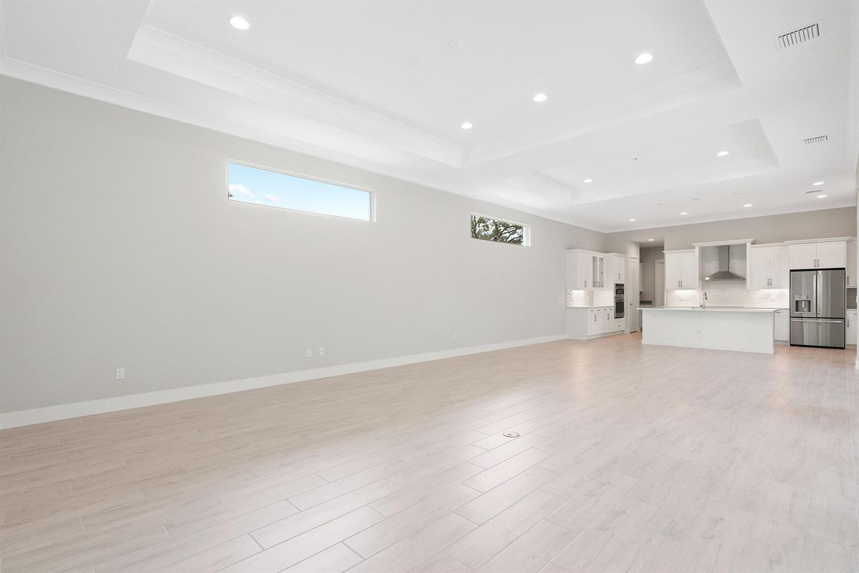 Empty room, Interior, Kitchen, Recessed Lighting, Stainless Steel Appliances, Wood Texture Flooring