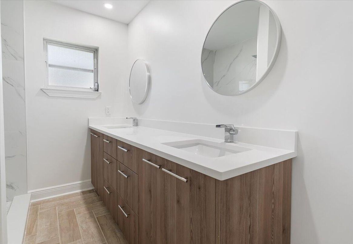 Bathroom, Dual Sink Vanities, Interior, Marble Walls, Recessed Lighting, Wood Texture Flooring
