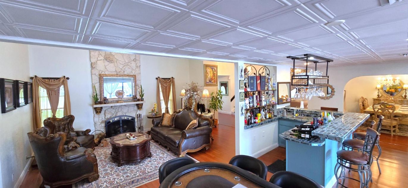 Chandelier, Dining room, Fireplace, Interior, Living room, Stone Walls, Wood Texture Flooring