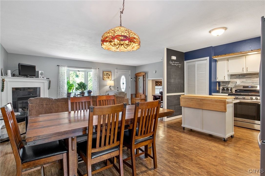 Dining room, Fireplace, Interior, Kitchen, Pendant Lights, Stainless Steel Appliances, Wood Texture Flooring