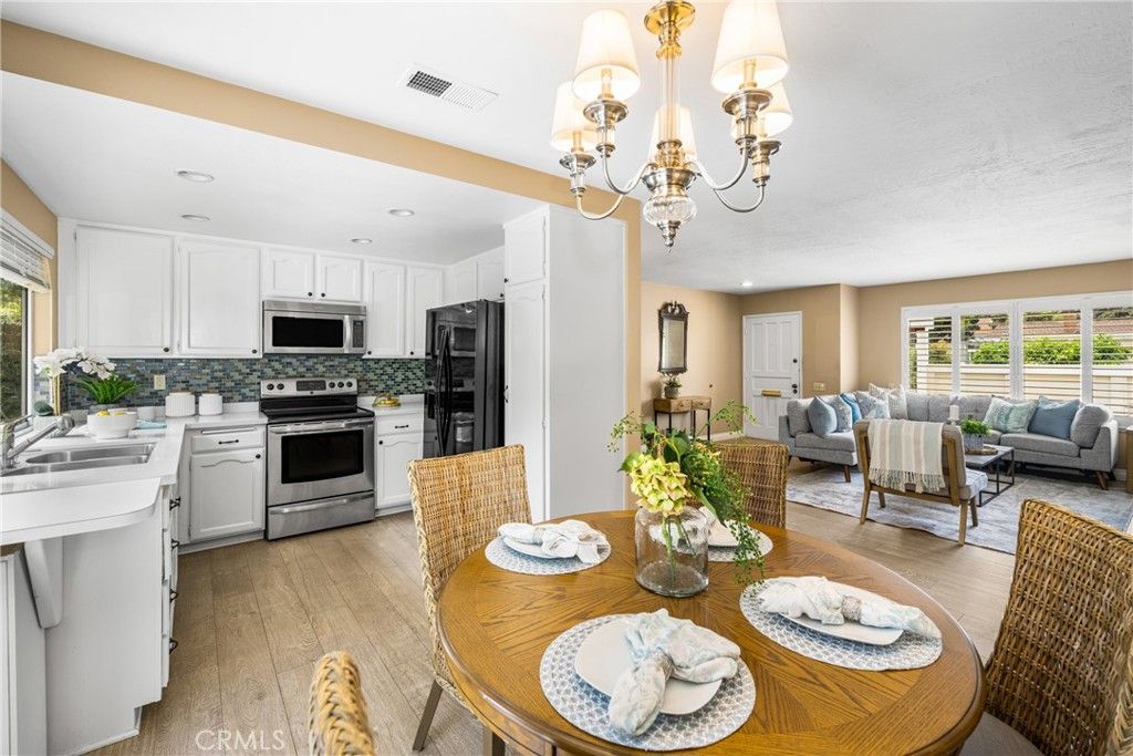 Chandelier, Dining room, Interior, Kitchen, Living room, Recessed Lighting, Stainless Steel Appliances, Wood Texture Flooring