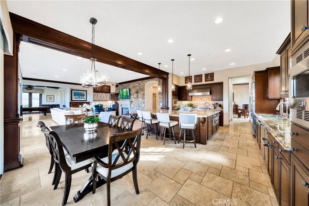 Chandelier, Dining room, Fireplace, Interior, Kitchen, Living room, Pendant Lights, Recessed Lighting, Stainless Steel Appliances