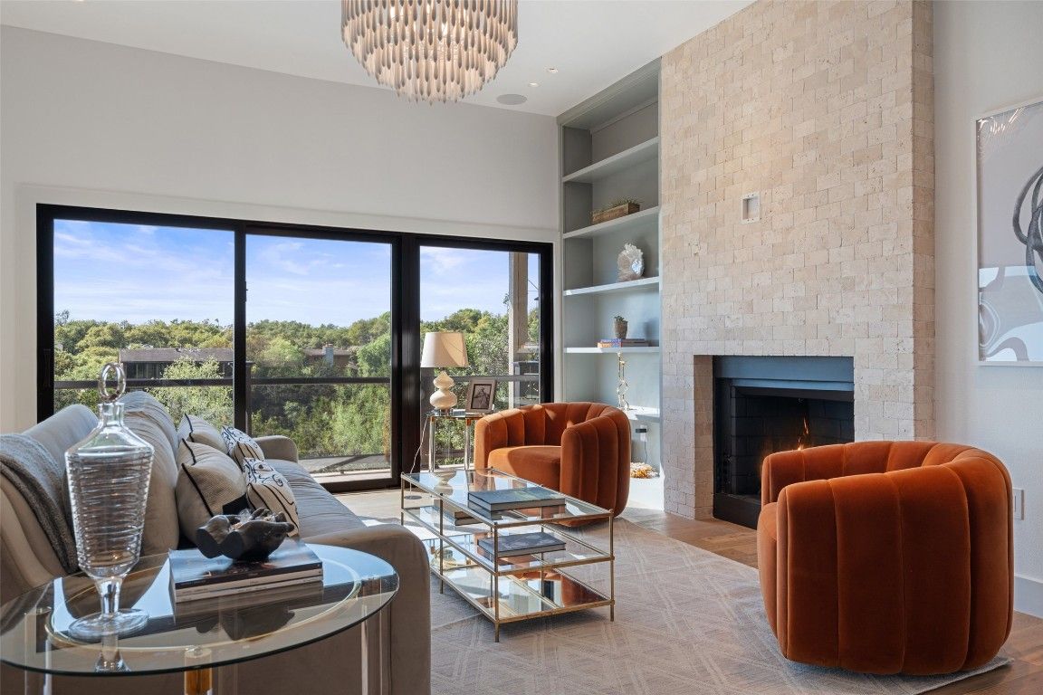 Chandelier, Fireplace, Interior, Living room, Recessed Lighting, Stone Walls, Wood Texture Flooring