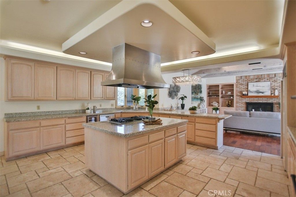 Chandelier, Fireplace, Interior, Kitchen, Living room, Recessed Lighting, Stainless Steel Appliances, Stone Walls, Wood Texture Flooring