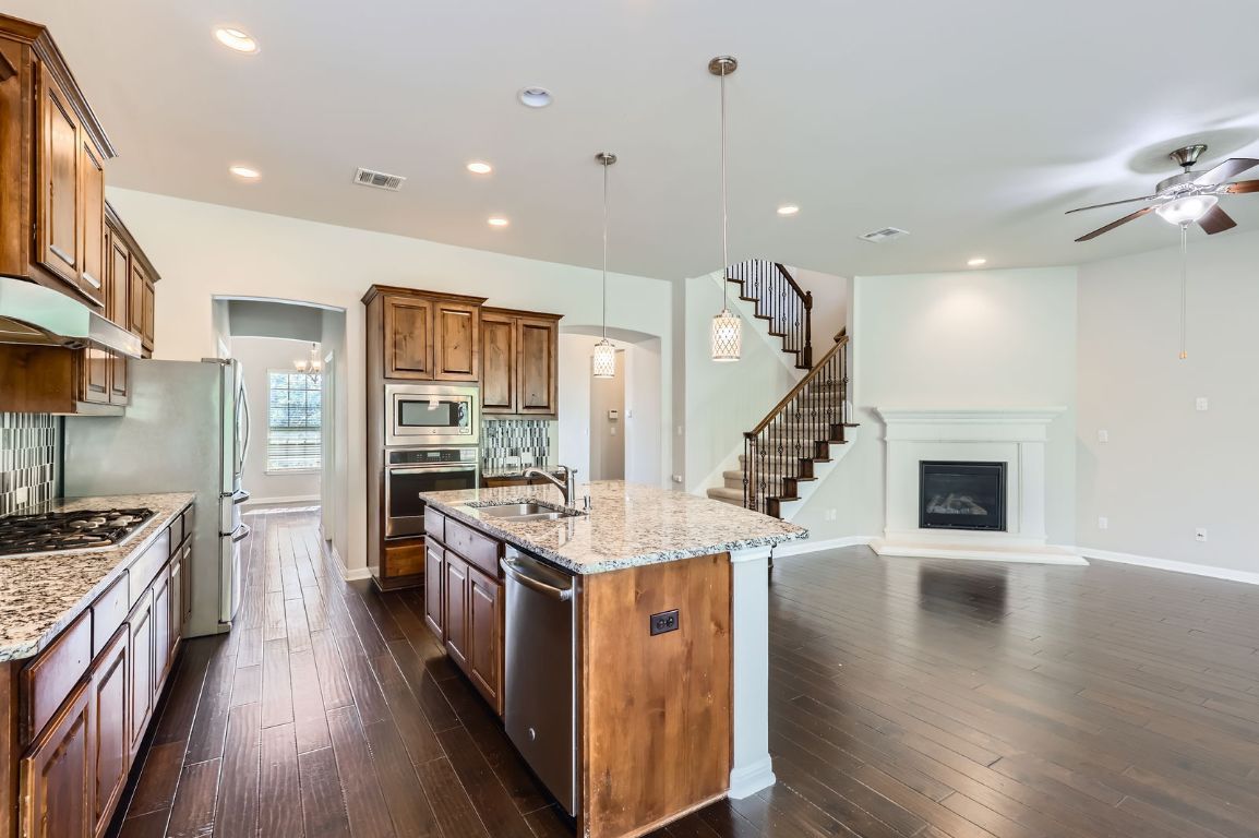 Fireplace, Interior, Kitchen, Pendant Lights, Recessed Lighting, Stainless Steel Appliances, Wood Texture Flooring