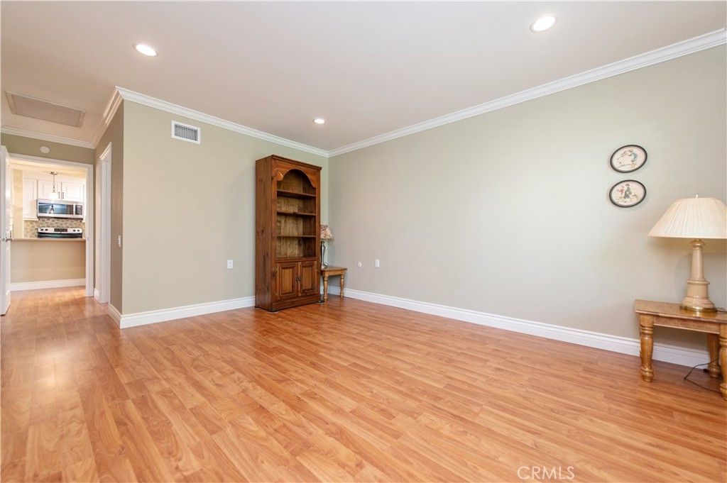 Empty room, Interior, Kitchen, Recessed Lighting, Stainless Steel Appliances, Wood Texture Flooring