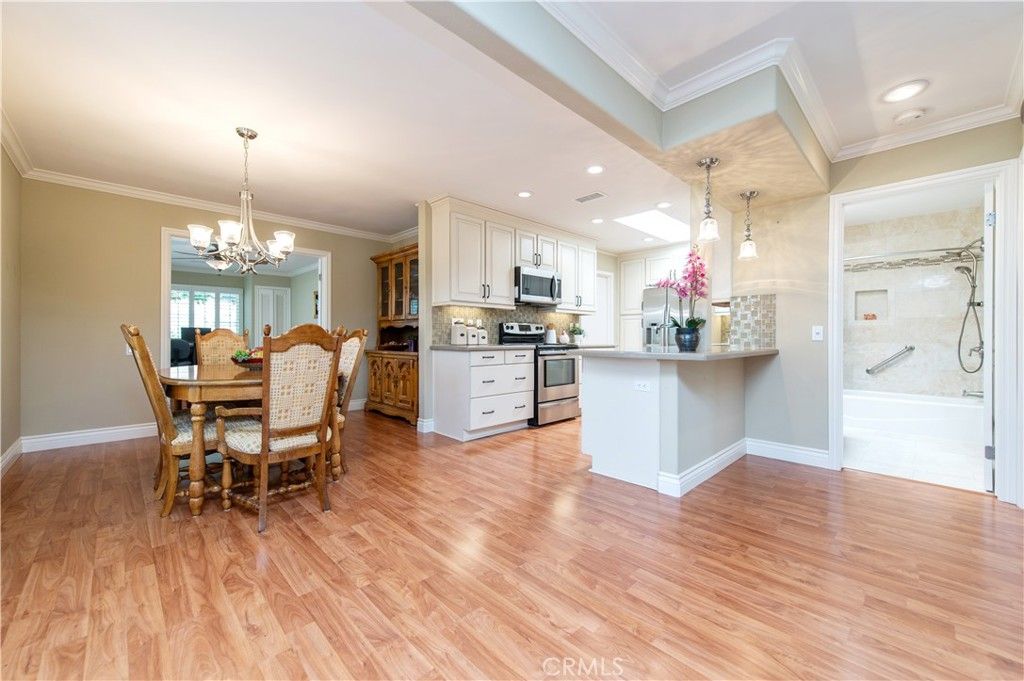 Chandelier, Dining room, Interior, Kitchen, Pendant Lights, Recessed Lighting, Stainless Steel Appliances, Wood Texture Flooring