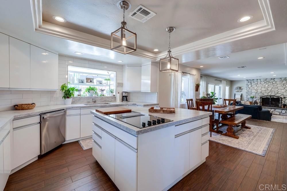 Dining room, Fireplace, Interior, Kitchen, Pendant Lights, Recessed Lighting, Stainless Steel Appliances, Stone Walls, Wood Texture Flooring