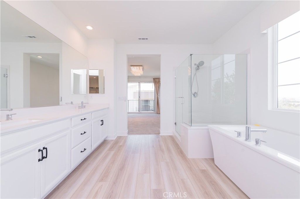 Bathroom, Dual Sink Vanities, Free Standing Baths, Glass Shower, Interior, Recessed Lighting, Wood Texture Flooring