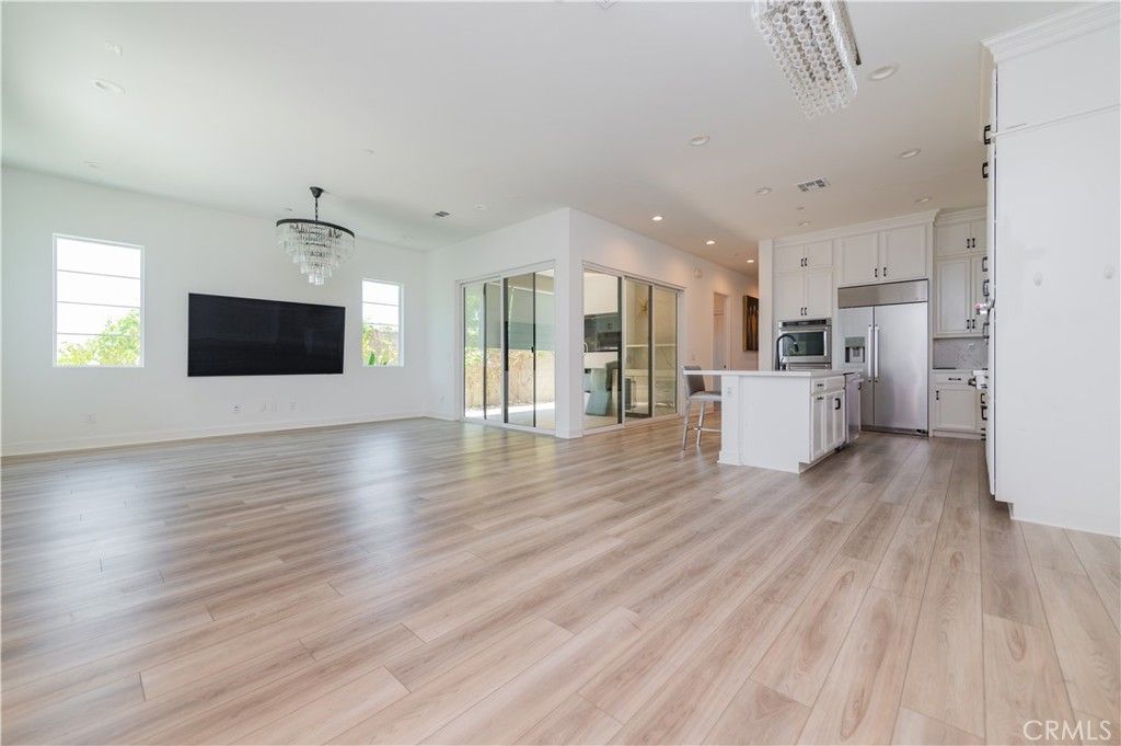 Chandelier, Empty room, Interior, Kitchen, Recessed Lighting, Stainless Steel Appliances, Wood Texture Flooring