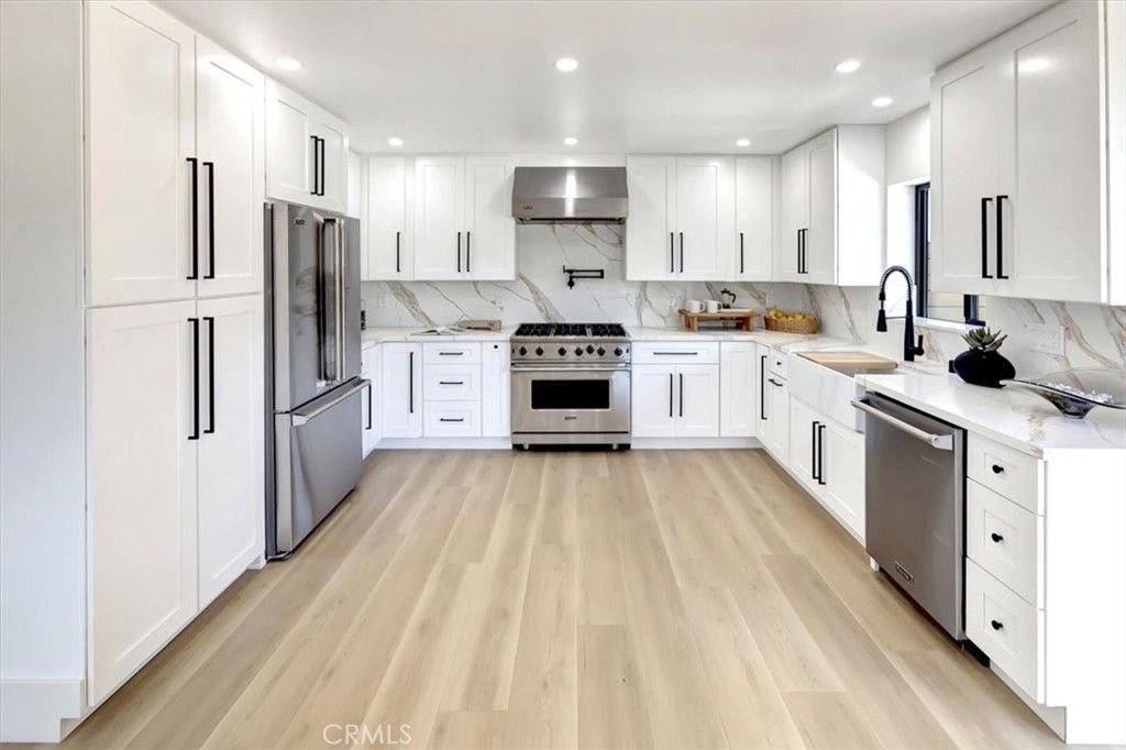 Interior, Kitchen, Marble Walls, Recessed Lighting, Stainless Steel Appliances, Wood Texture Flooring