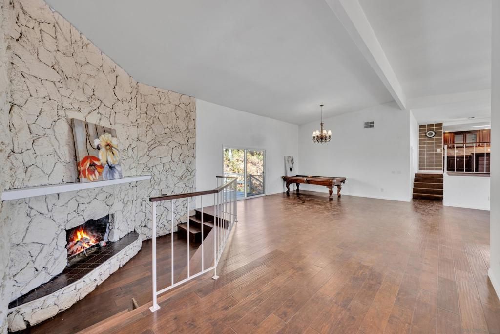 Billiard Table, Chandelier, Fireplace, Game Room, Interior, Stone Walls, Wood Texture Flooring