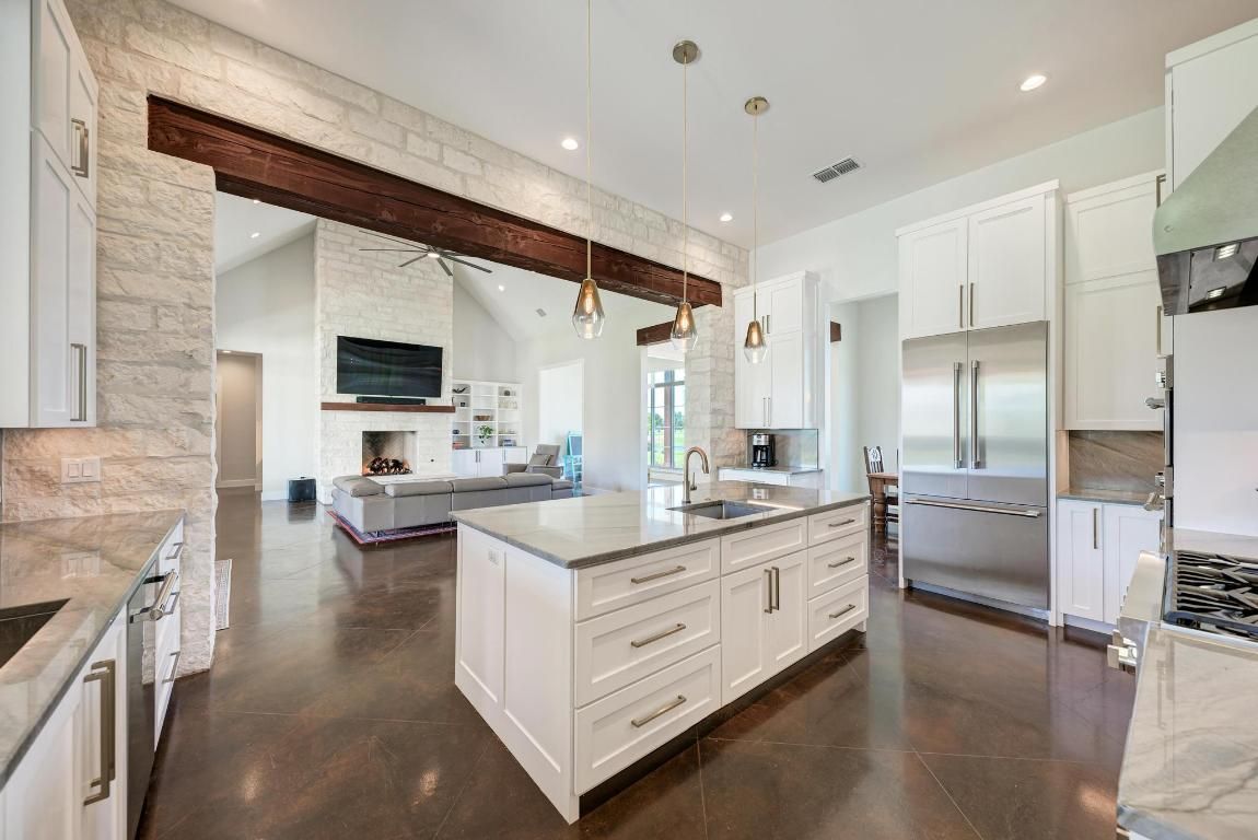 Fireplace, Interior, Kitchen, Living room, Pendant Lights, Recessed Lighting, Stainless Steel Appliances, Stone Walls