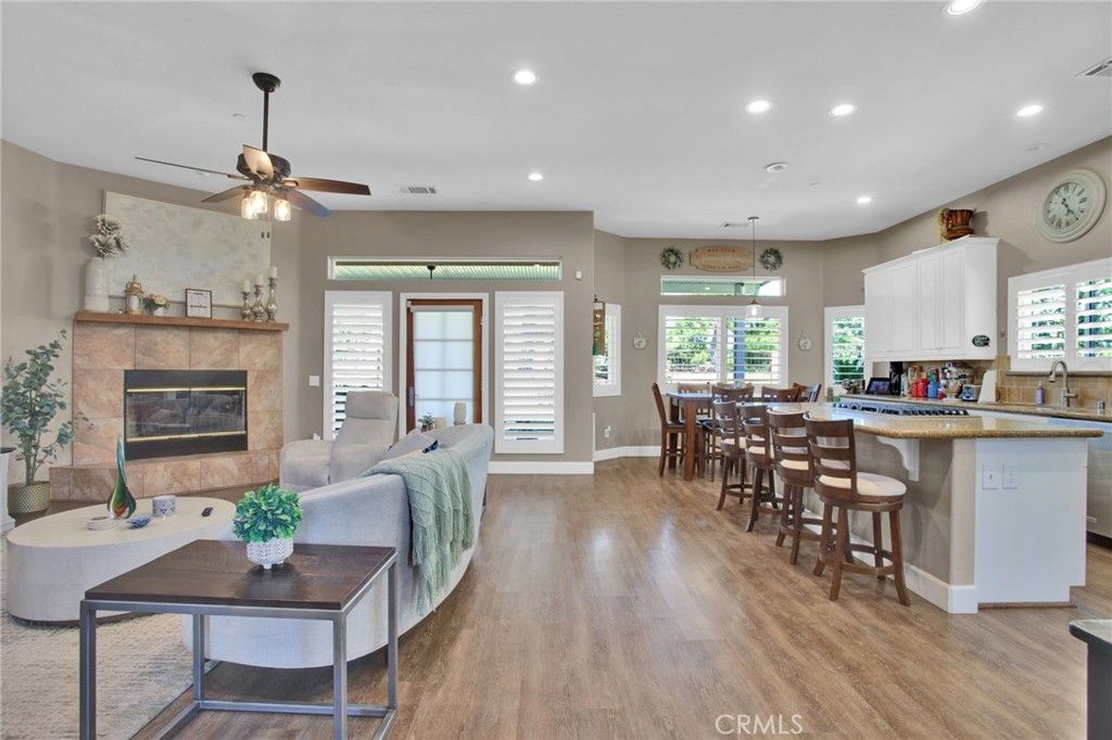Dining room, Fireplace, Interior, Living room, Recessed Lighting, Stone Walls, Wood Texture Flooring