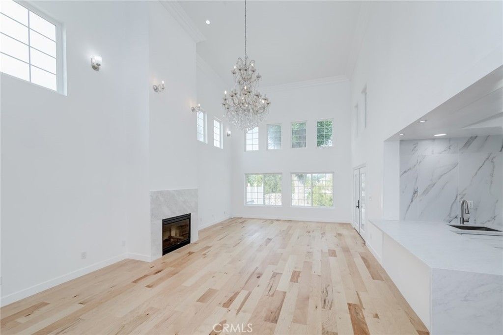 Chandelier, Fireplace, Interior, Marble Walls, Recessed Lighting, Wood Texture Flooring