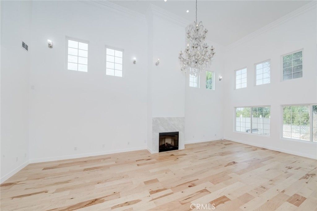 Chandelier, Empty room, Fireplace, Interior, Recessed Lighting, Wood Texture Flooring