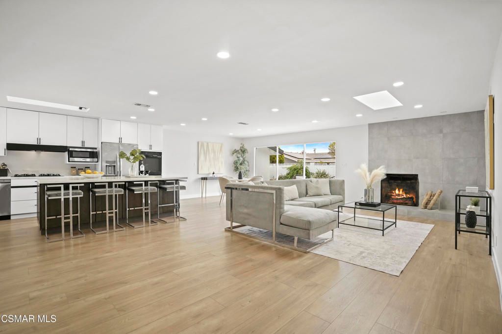 Fireplace, Interior, Kitchen, Living room, Pendant Lights, Recessed Lighting, Stainless Steel Appliances, Wood Texture Flooring