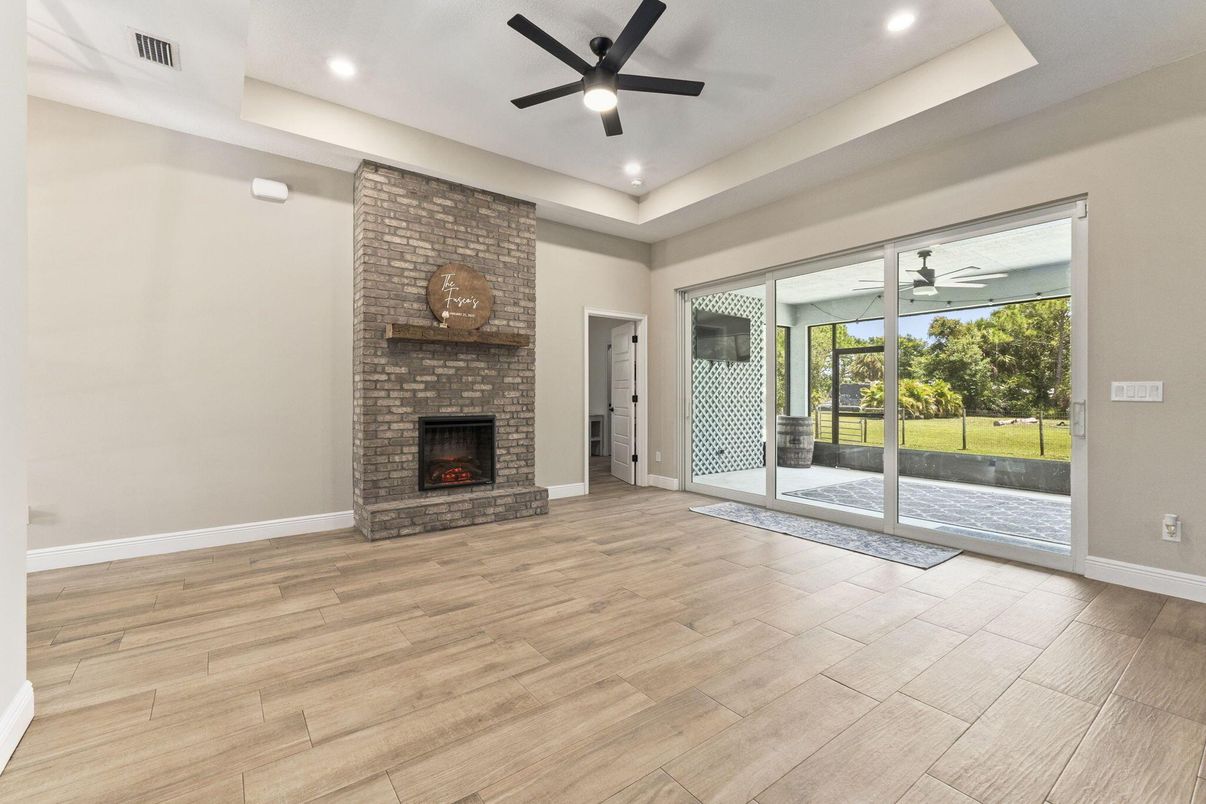Empty room, Fireplace, Interior, Recessed Lighting, Stone Walls, Wood Texture Flooring