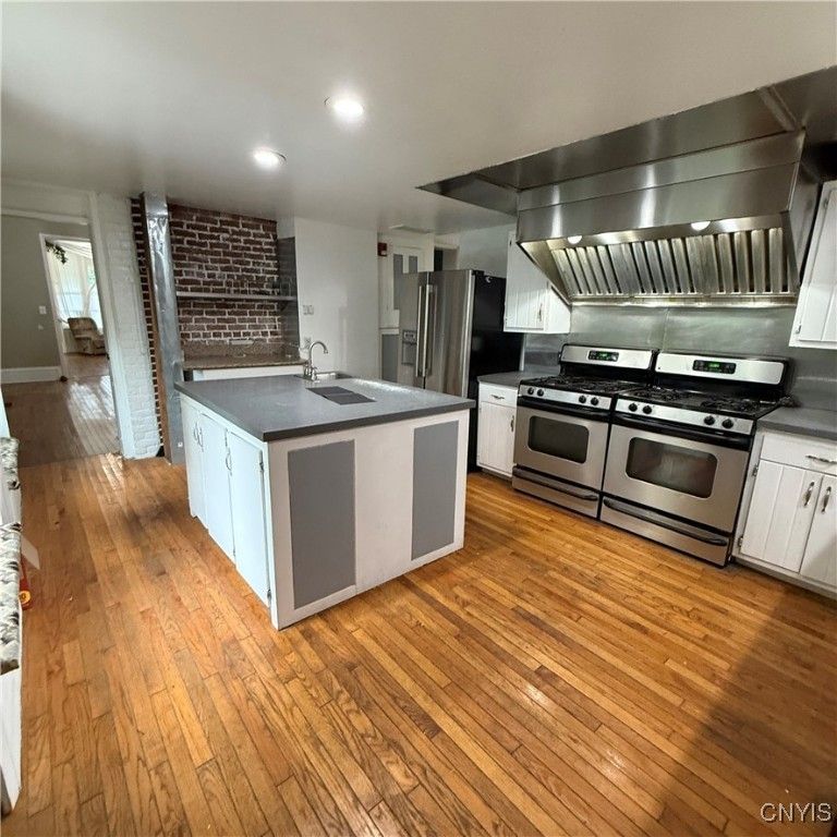 Interior, Kitchen, Recessed Lighting, Stainless Steel Appliances, Stone Walls, Wood Texture Flooring