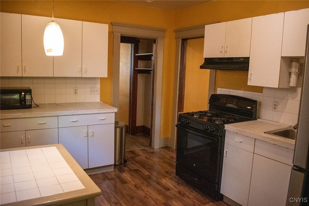 Interior, Kitchen, Pendant Lights, Tile Countertops, Wood Texture Flooring