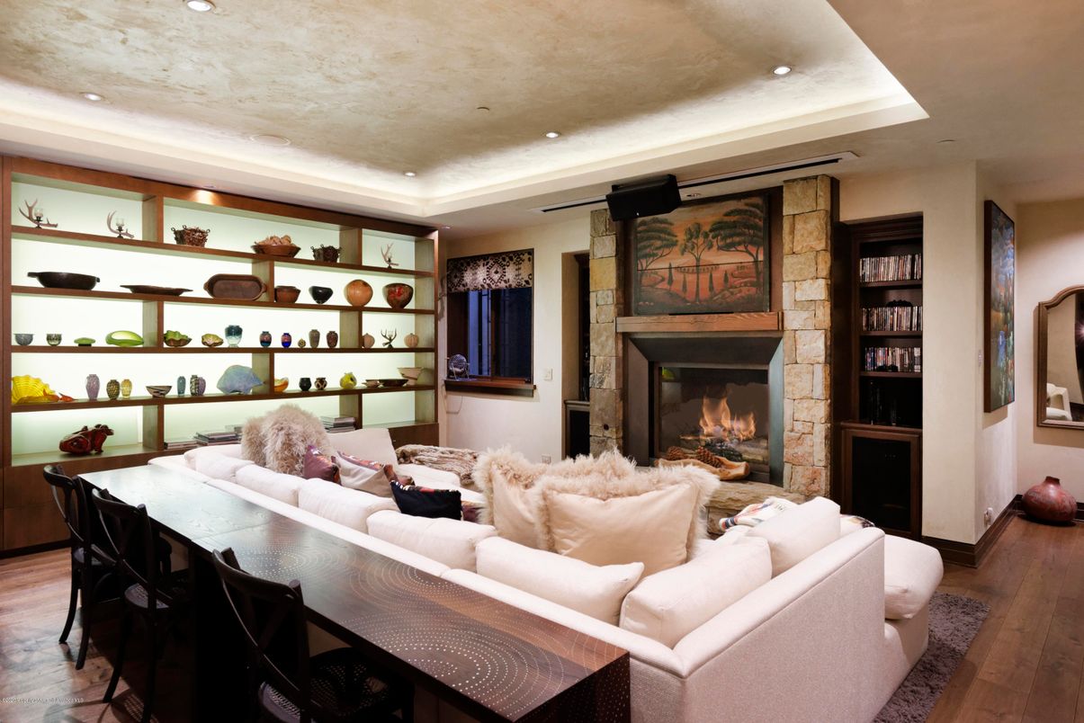 Dining room, Fireplace, Interior, Living room, Recessed Lighting, Stone Walls, Wood Texture Flooring