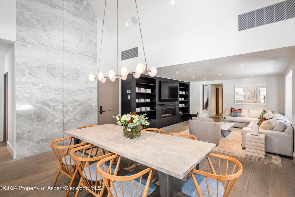 Dining room, Fireplace, Interior, Living room, Marble Walls, Pendant Lights, Recessed Lighting, Wood Texture Flooring