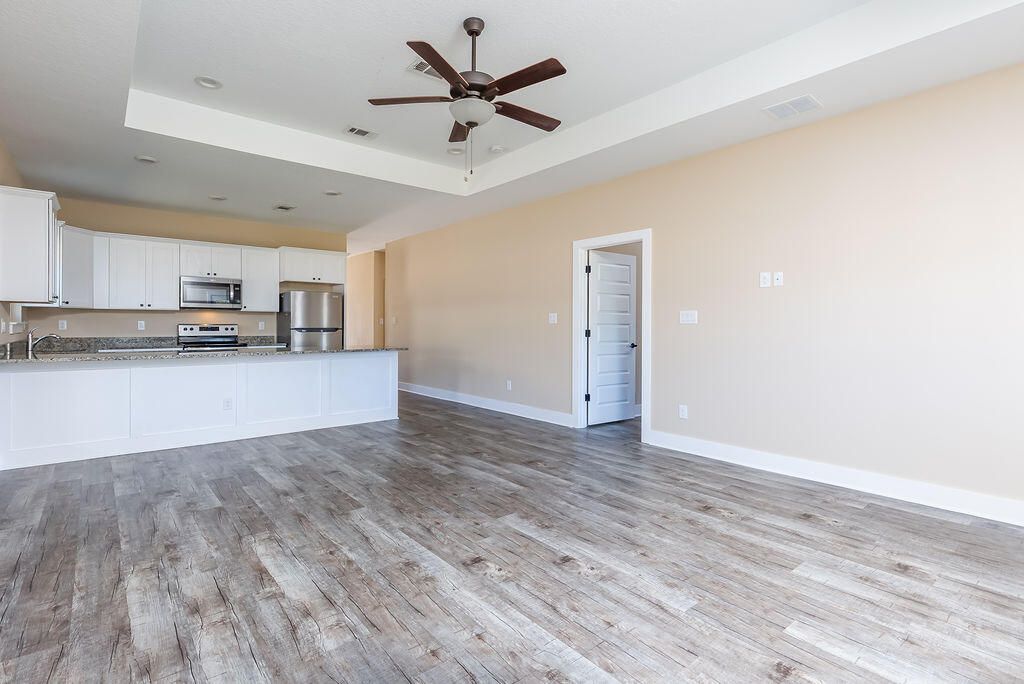 Empty room, Interior, Kitchen, Recessed Lighting, Stainless Steel Appliances, Wood Texture Flooring