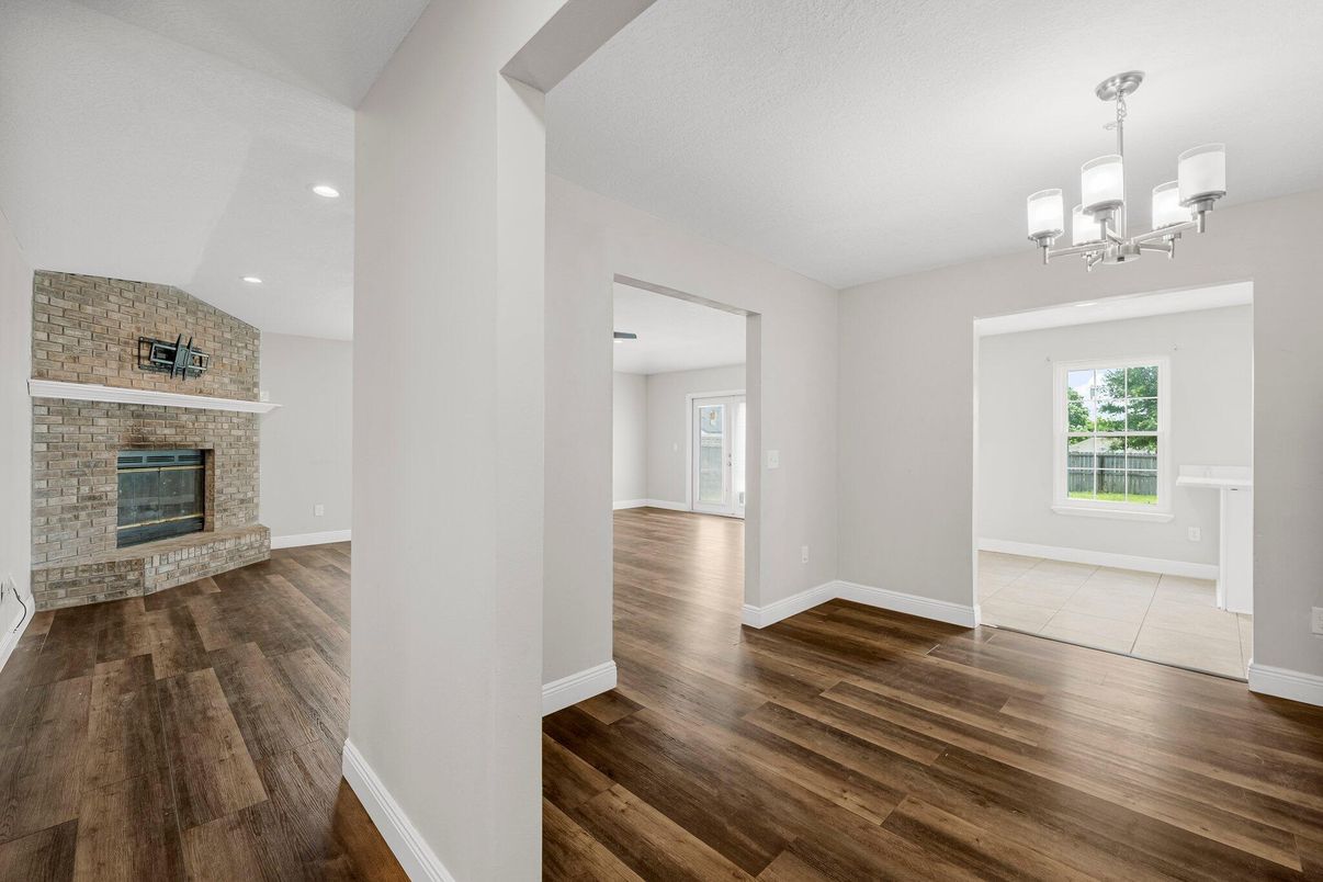 Chandelier, Empty room, Fireplace, Interior, Recessed Lighting, Stone Walls, Wood Texture Flooring