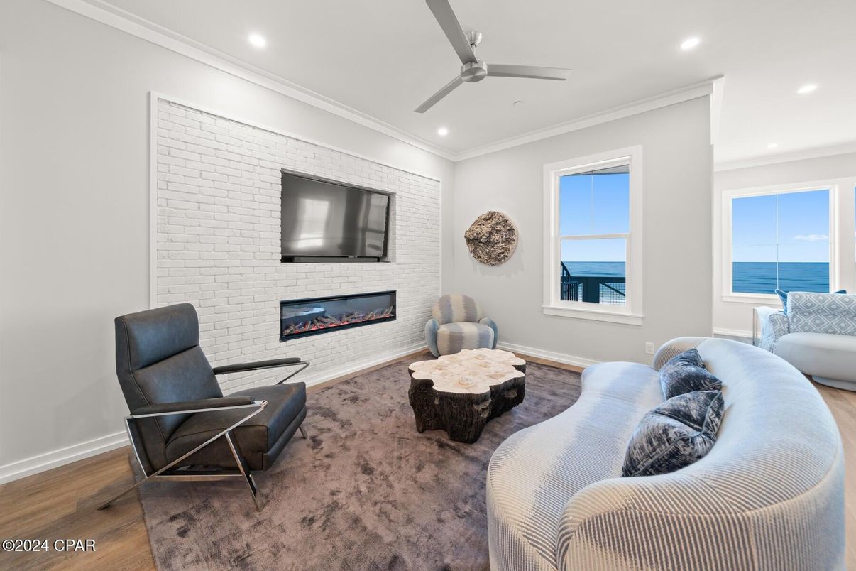 Fireplace, Interior, Living room, Recessed Lighting, Stone Walls, Water, Wood Texture Flooring