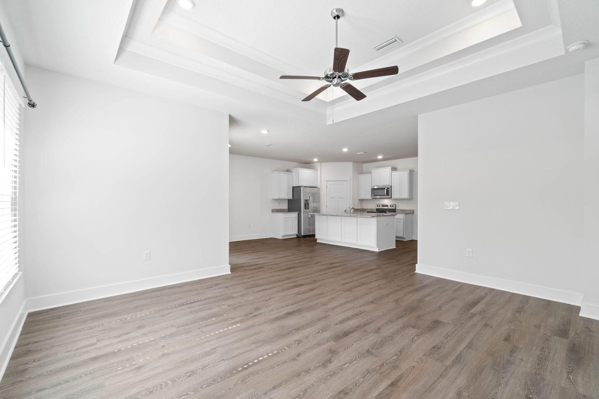 Empty room, Interior, Kitchen, Recessed Lighting, Stainless Steel Appliances, Wood Texture Flooring