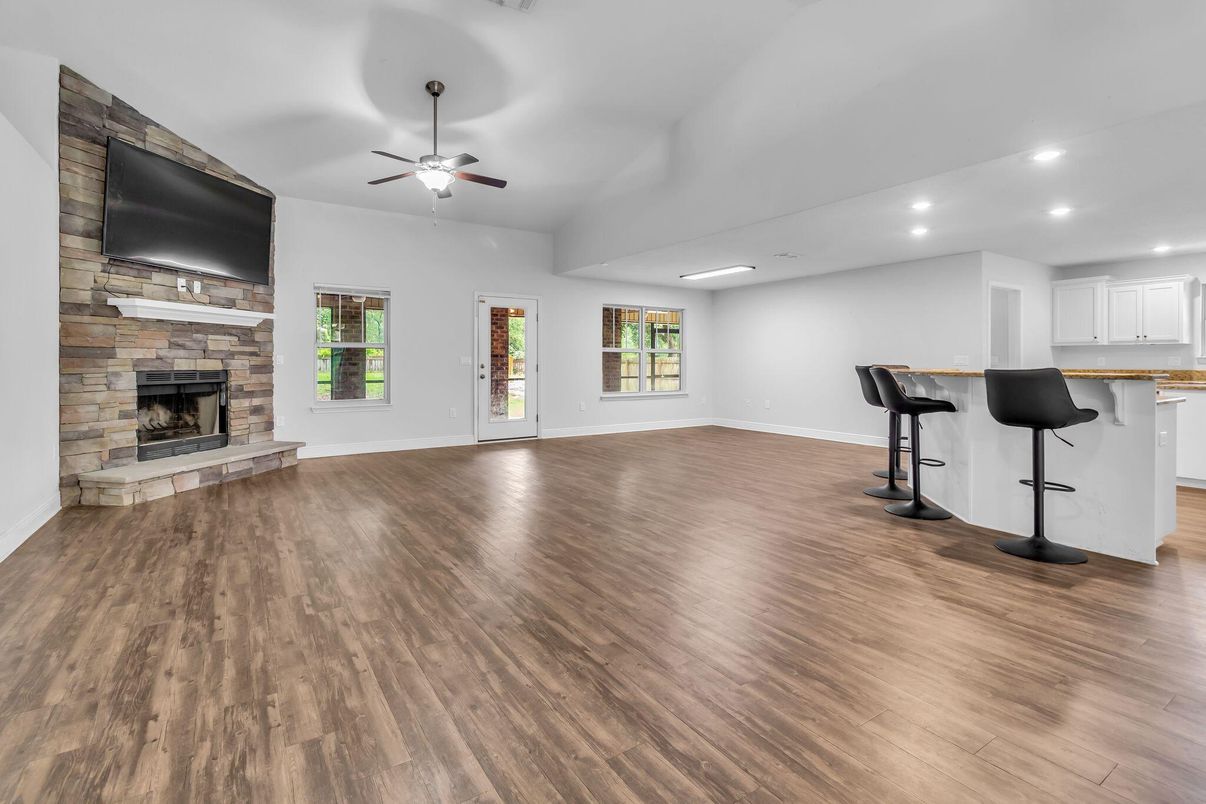 Empty room, Fireplace, Interior, Recessed Lighting, Stone Walls, Wood Texture Flooring