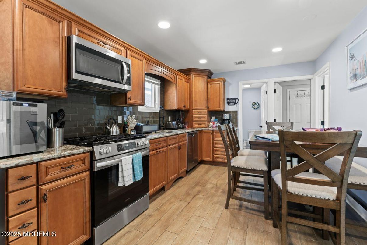 Dining room, Interior, Kitchen, Recessed Lighting, Stainless Steel Appliances, Wood Texture Flooring