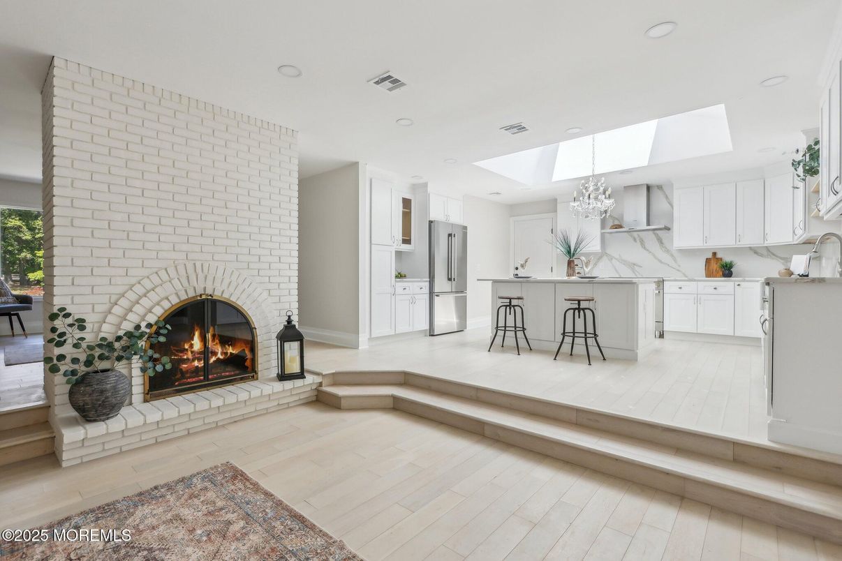 Chandelier, Fireplace, Interior, Kitchen, Marble Walls, Recessed Lighting, Stone Walls, Wood Texture Flooring