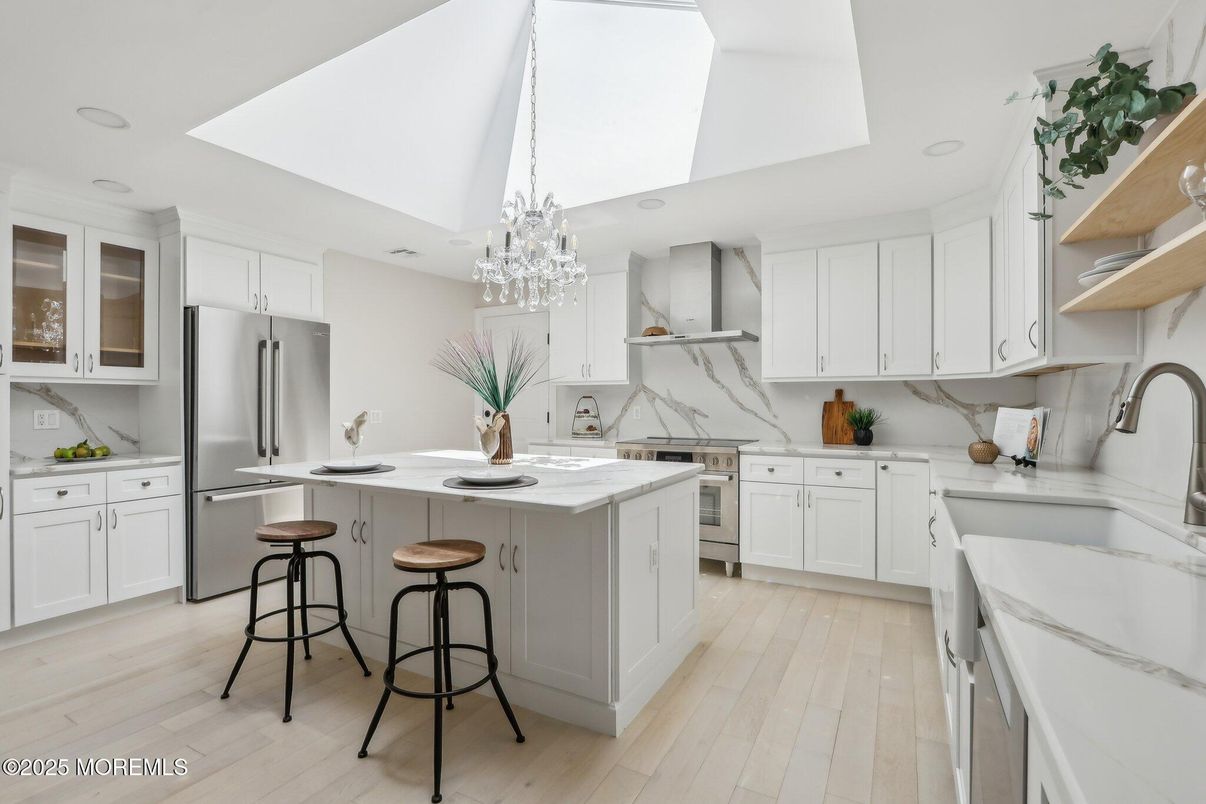 Chandelier, Interior, Kitchen, Marble Walls, Recessed Lighting, Stainless Steel Appliances, Wood Texture Flooring