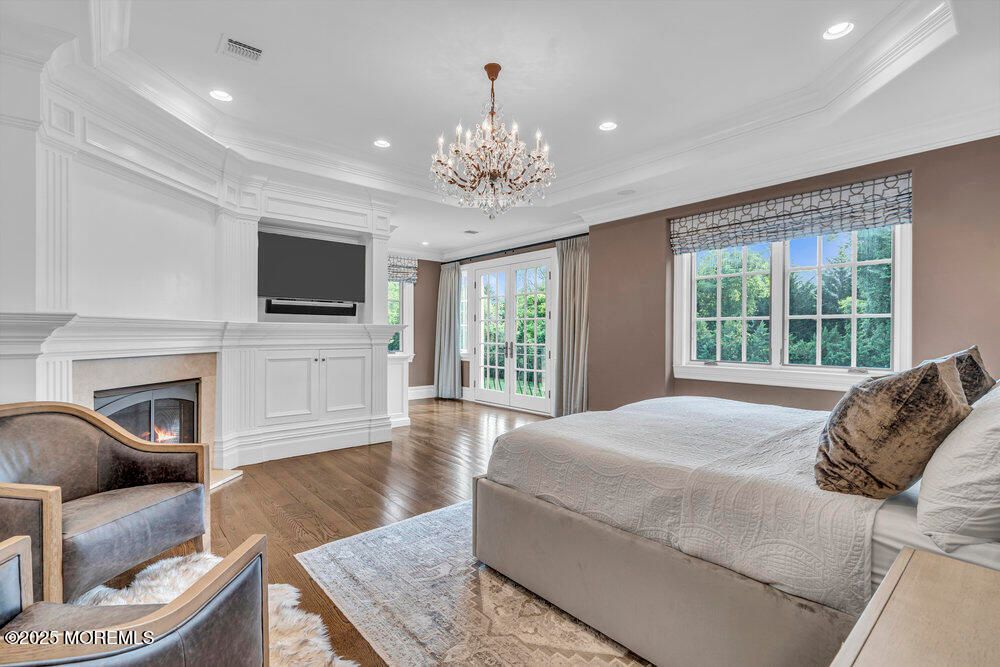 Bedroom, Chandelier, Fireplace, Interior, Recessed Lighting, Wood Texture Flooring