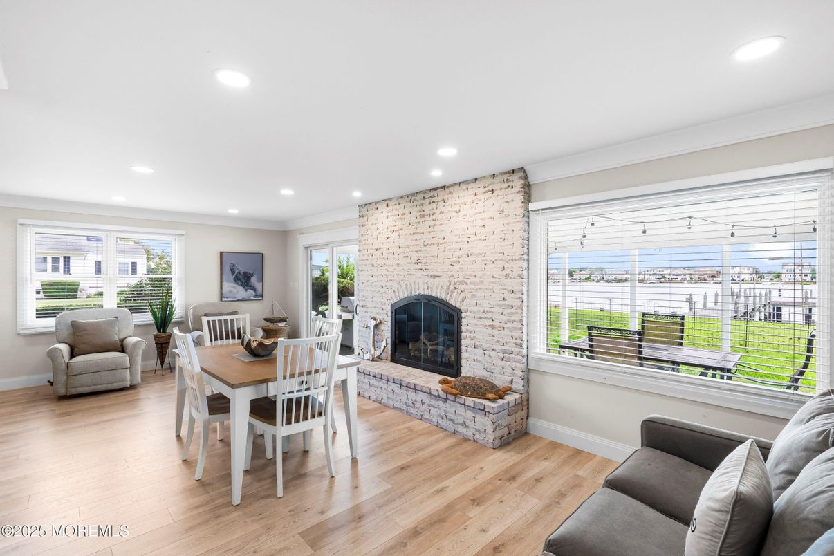 Dining room, Fireplace, Interior, Living room, Recessed Lighting, Stone Walls, Wood Texture Flooring