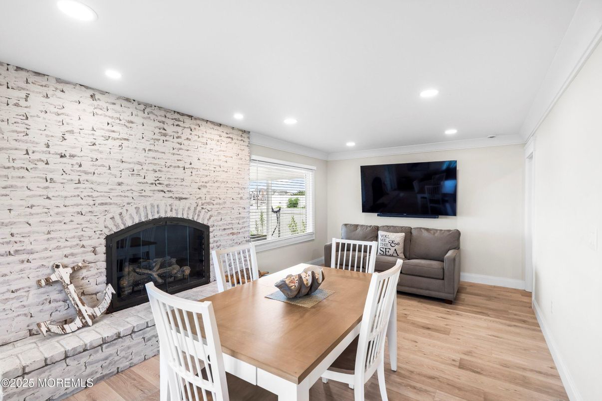 Dining room, Fireplace, Interior, Recessed Lighting, Stone Walls, Wood Texture Flooring