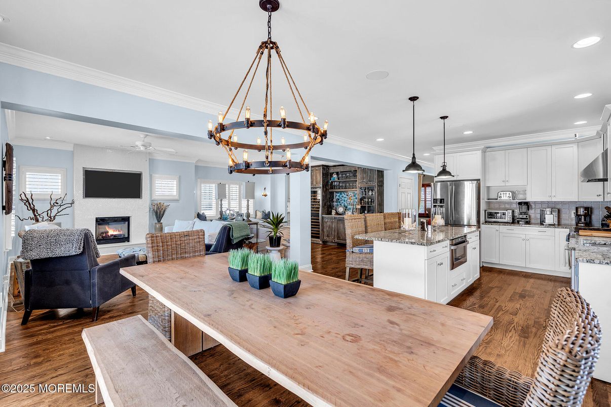 Chandelier, Dining room, Fireplace, Interior, Kitchen, Living room, Pendant Lights, Recessed Lighting, Stainless Steel Appliances, Wood Texture Flooring