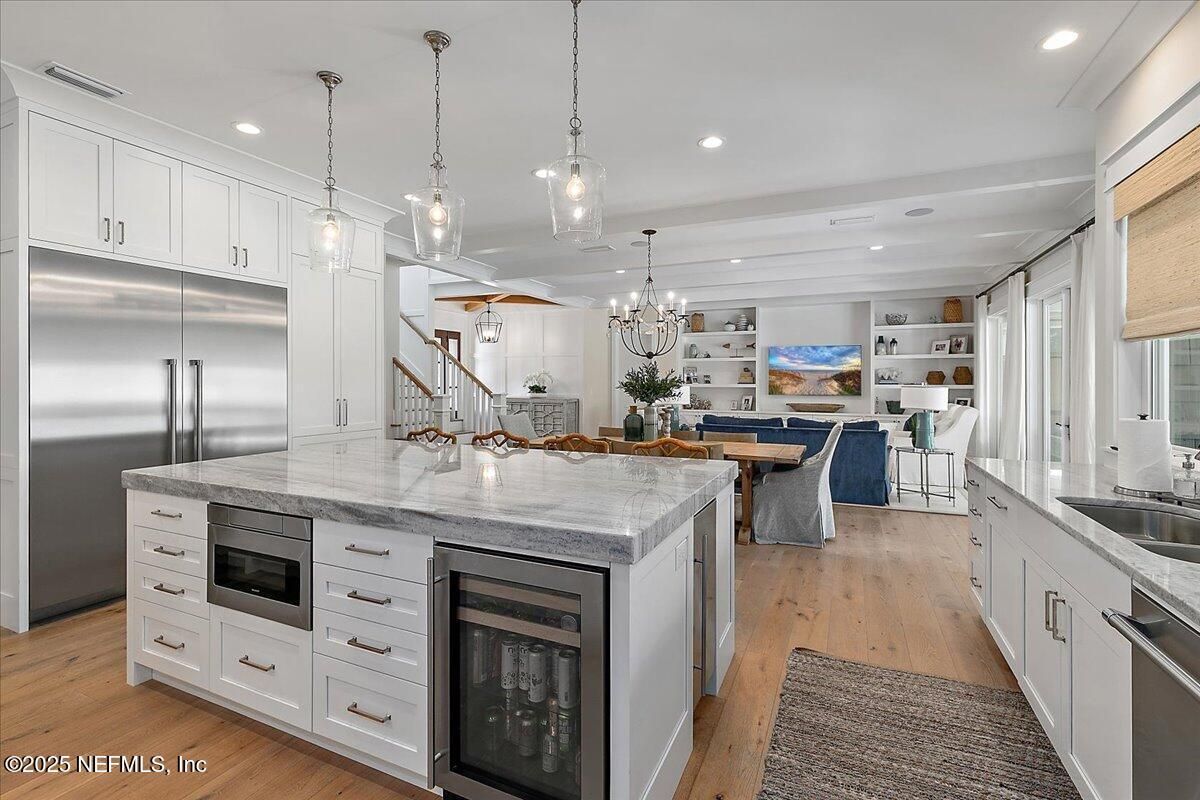 Chandelier, Dining room, Interior, Kitchen, Living room, Pendant Lights, Recessed Lighting, Stainless Steel Appliances, Wood Texture Flooring