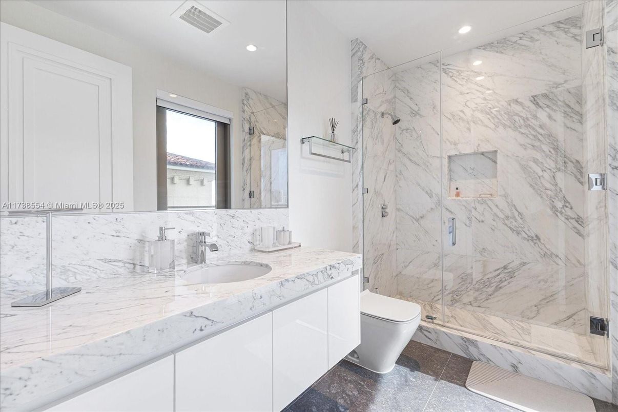 Bathroom, Dual Sink Vanities, Glass Shower, Interior, Marble, Marble Walls, Recessed Lighting