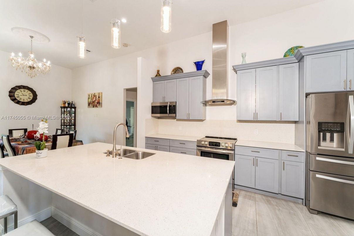Chandelier, Dining room, Interior, Kitchen, Pendant Lights, Stainless Steel Appliances, Wood Texture Flooring