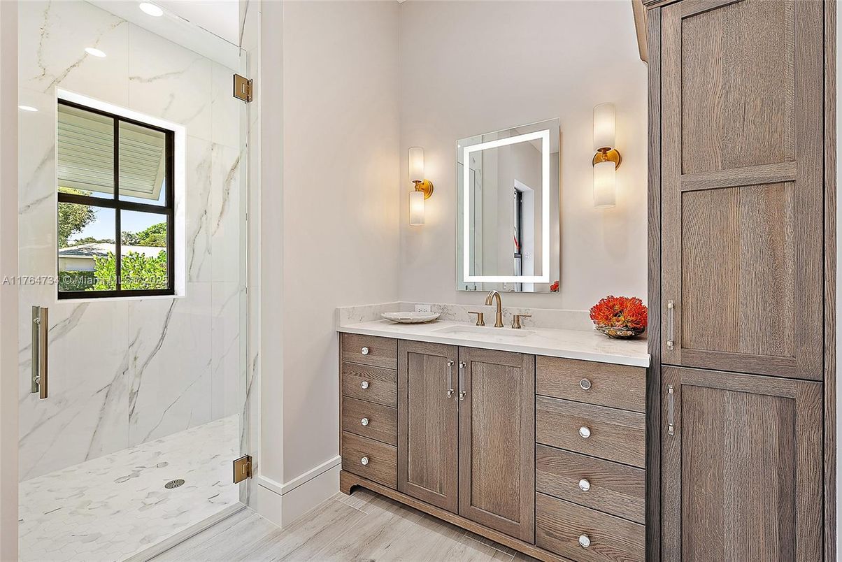 Bathroom, Dual Sink Vanities, Glass Shower, Interior, Marble Walls, Wood Texture Flooring