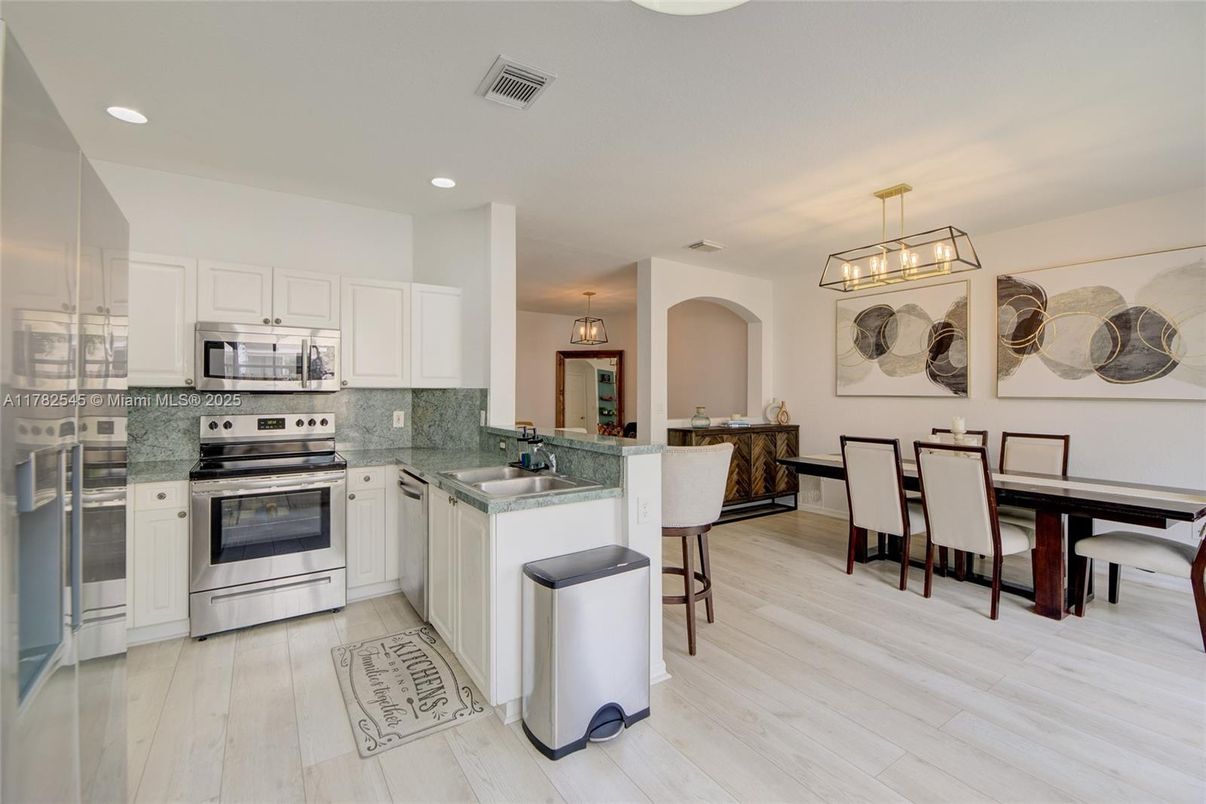 Dining room, Interior, Kitchen, Pendant Lights, Recessed Lighting, Stainless Steel Appliances, Wood Texture Flooring